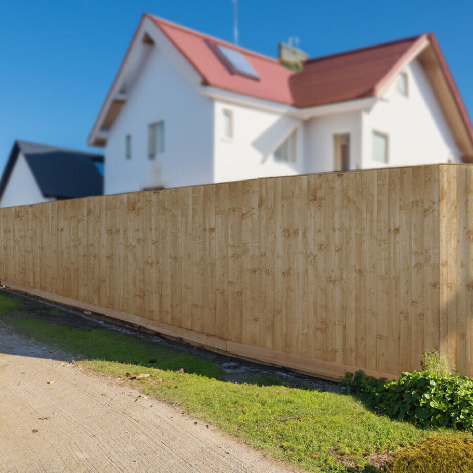 Large house with a tall fence