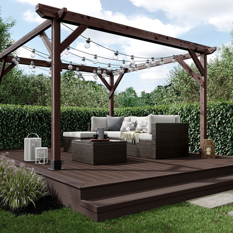 A garden with a deck, pergola and garden furniture