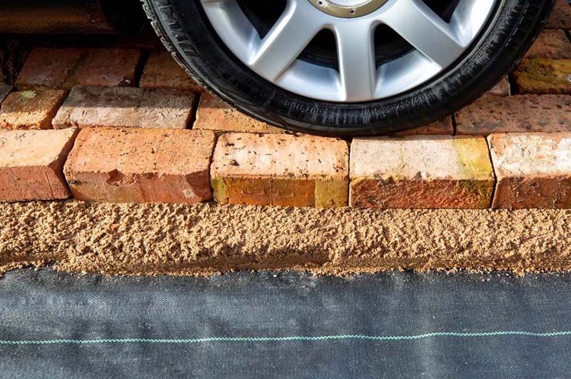 apollo-premium-weed-control-fabric-1m-x-14m-roll-ls-featuring-a-car-wheel