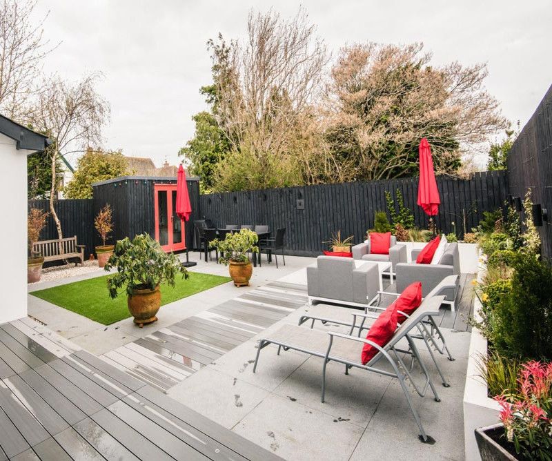 Back garden with garden buildings, garden furniture and decking