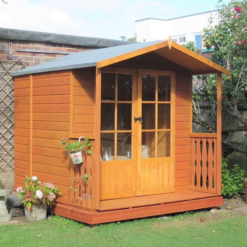 A summerhouse next to a garden fence